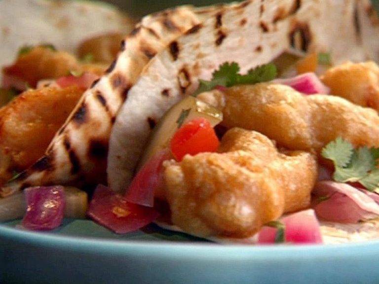 Beer Battered fish Tacos with Quick Pickled Onions and Cucumber and Chipotle Crema